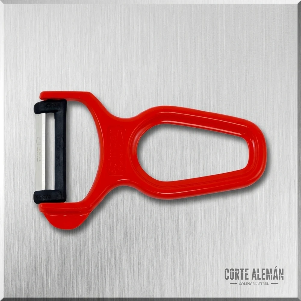 Pelador de verduras o pelador transversal de Solingen, rojo, en fondo metálico